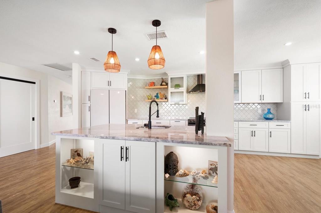 2505 Bay Boulevard, Unit 4 Indian Rocks Beach, FL 33785 - Photo 7 of 63 a very nice looking kitchen with granite countertop a white stove top oven