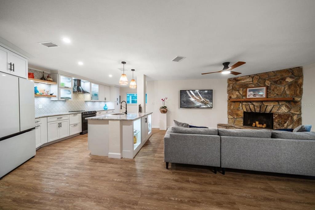 2505 Bay Boulevard, Unit 4 Indian Rocks Beach, FL 33785 - Photo 9 of 63 a living room with furniture and a fireplace