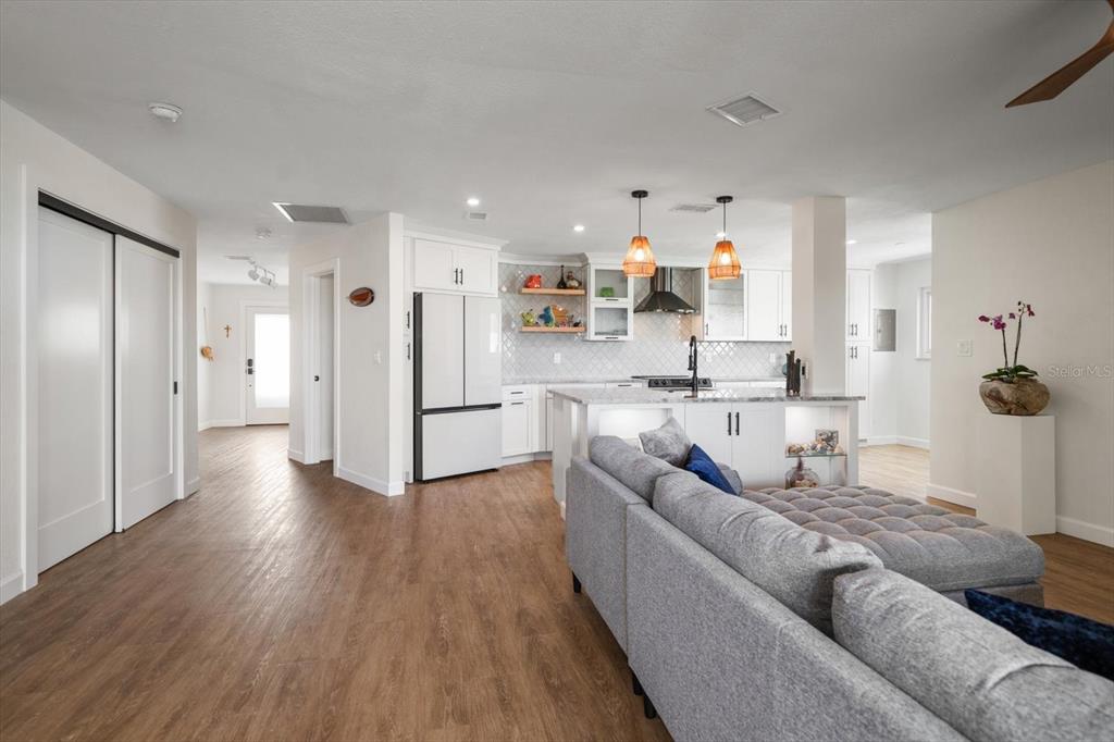 2505 Bay Boulevard, Unit 4 Indian Rocks Beach, FL 33785 - Photo 10 of 63 a living room with stainless steel appliances furniture and a wooden floor