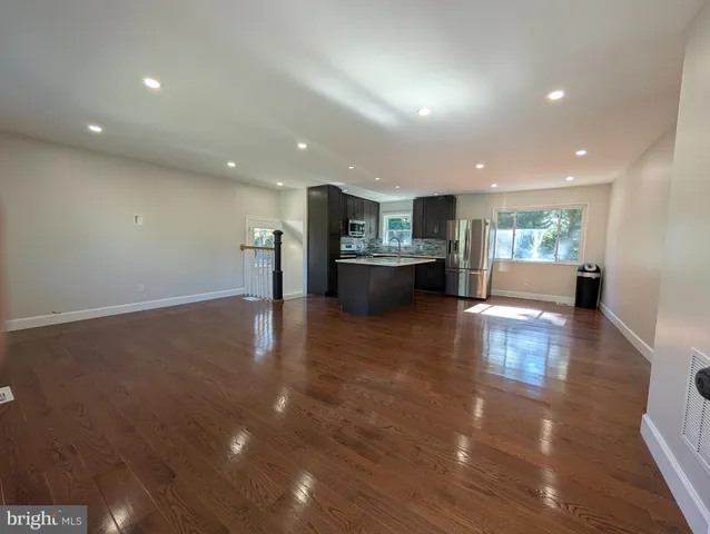 a view of kitchen with furniture and wooden floor