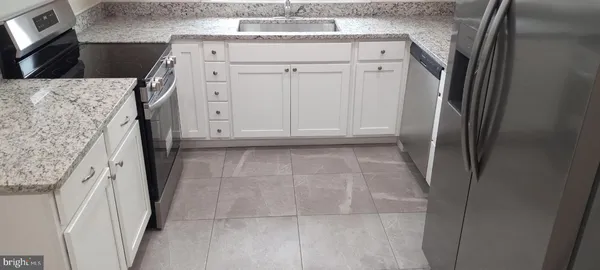 a view of a livingroom with an empty space and a window