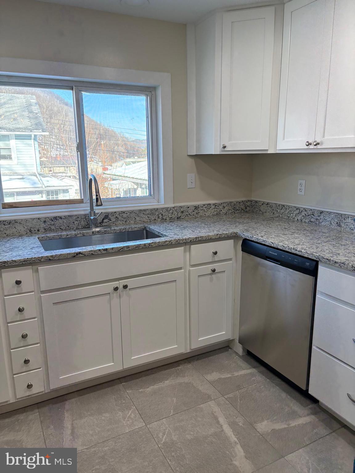 114 D Street Keyser, WV 26726 - Photo 14 of 37 a kitchen with granite countertop white cabinets and a sink