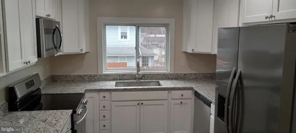 a kitchen with a sink stove and refrigerator