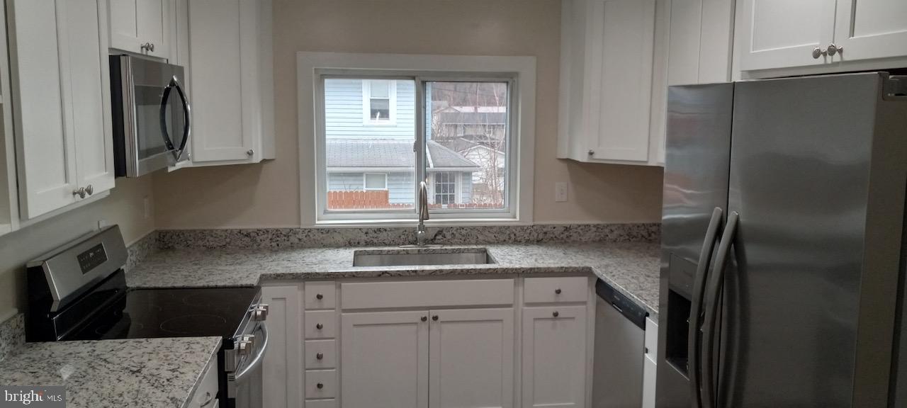 114 D Street Keyser, WV 26726 - Photo 24 of 37 a kitchen with a sink stove and refrigerator