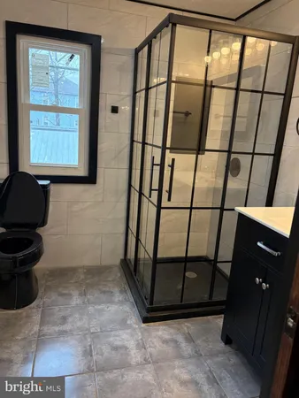 a bathroom with a window and a shower