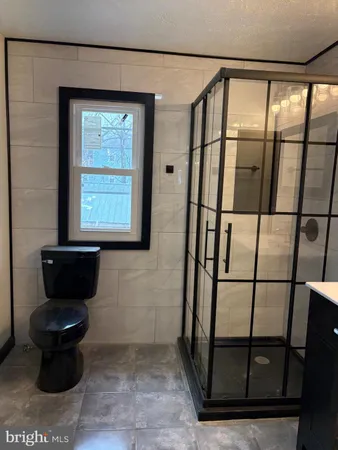 a bathroom with a toilet and a shower