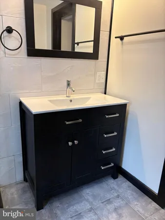 a bathroom with a sink vanity and mirror