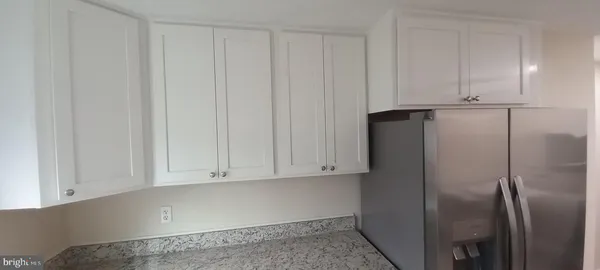 a view of cabinets and refrigerator