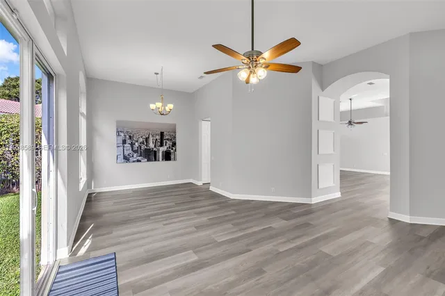 a view of empty room with wooden floor