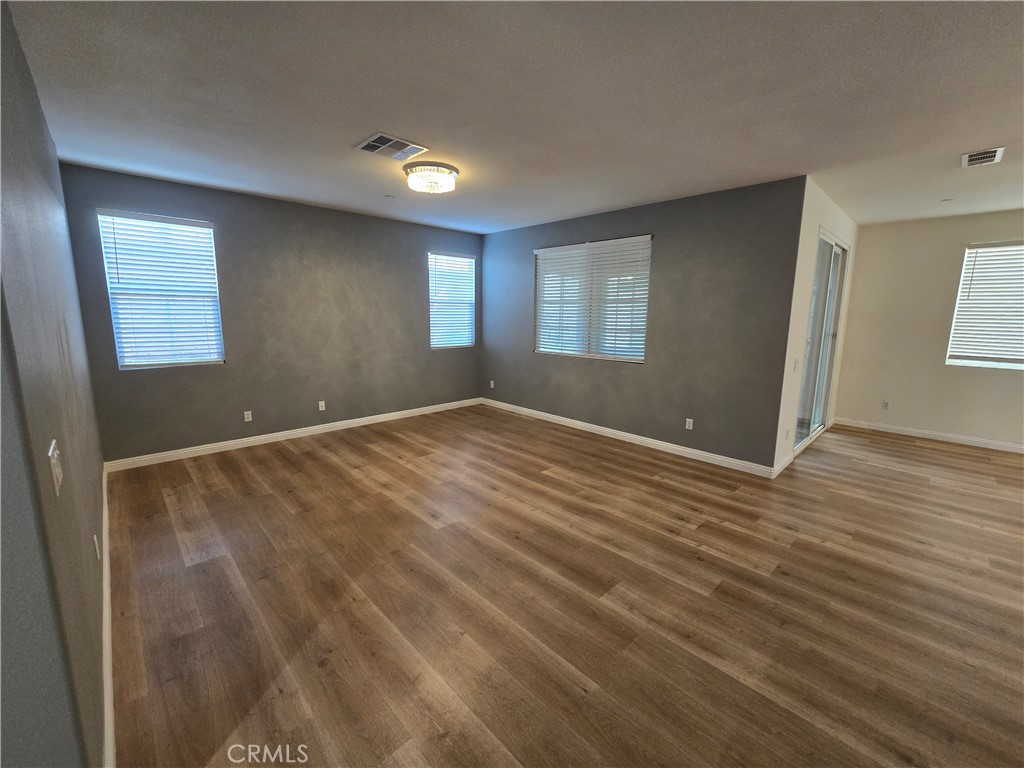 220 West Via Rua Flores Ontario, CA 91762 - Photo 11 of 51 a view of an empty room with wooden floor and a window