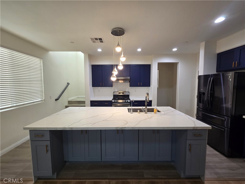 220 West Via Rua Flores Ontario, CA 91762 - Photo 16 of 51 a large kitchen with kitchen island a sink stainless steel appliances and cabinets