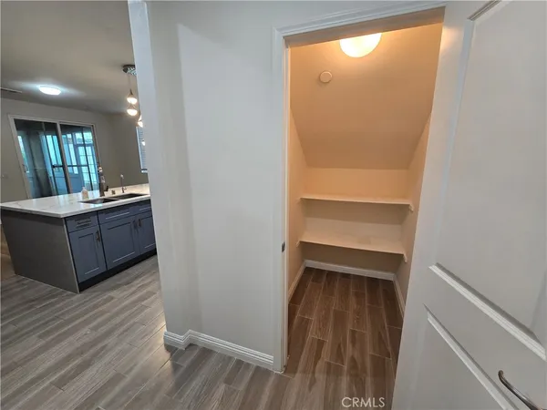 a view of walk in closet with wooden floor