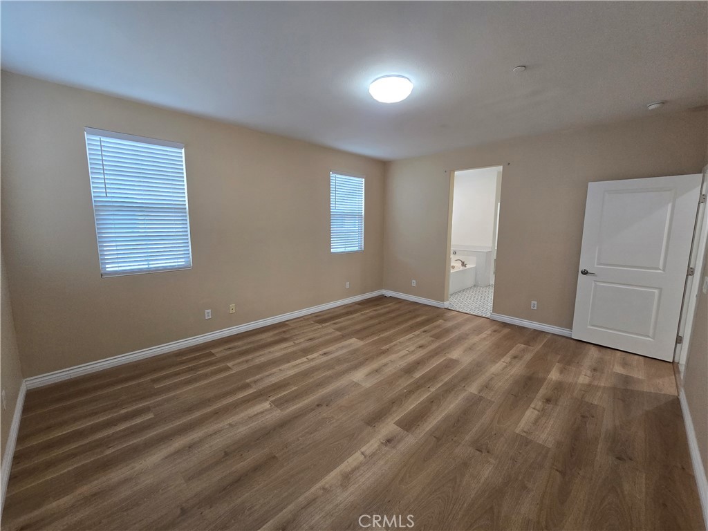 220 West Via Rua Flores Ontario, CA 91762 - Photo 29 of 51 a view of empty room with wooden floor and fan