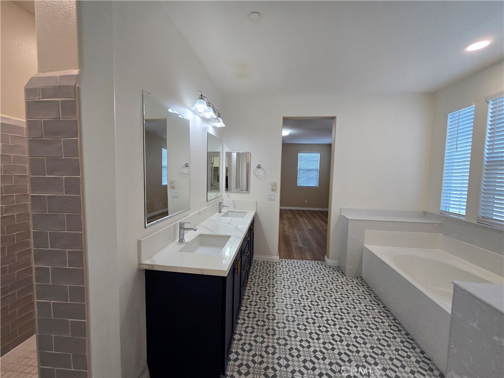 220 West Via Rua Flores Ontario, CA 91762 - Photo 36 of 51 a bathroom with a sink a mirror and a bathtub
