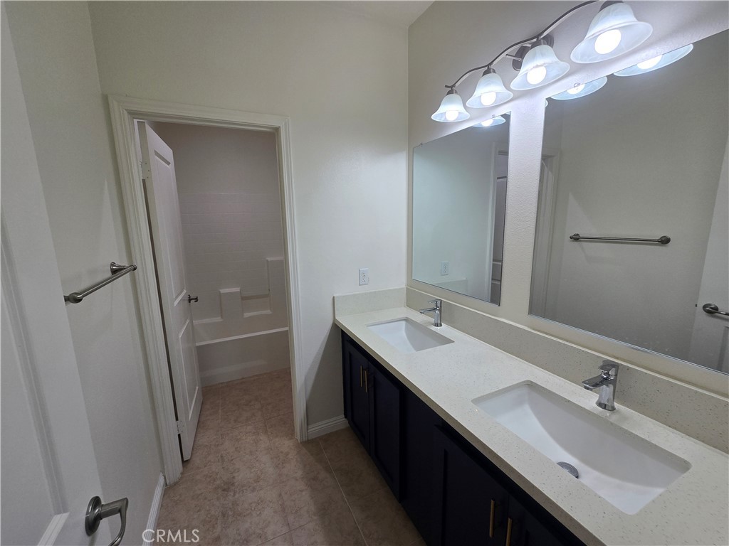 220 West Via Rua Flores Ontario, CA 91762 - Photo 39 of 51 a bathroom with a double vanity sink and a mirror
