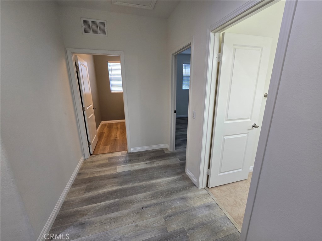 220 West Via Rua Flores Ontario, CA 91762 - Photo 41 of 51 a view of a hallway with wooden floor and closet