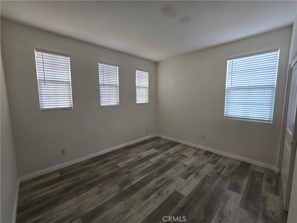 220 West Via Rua Flores Ontario, CA 91762 - Photo 42 of 51 a view of an empty room with wooden floor and a window