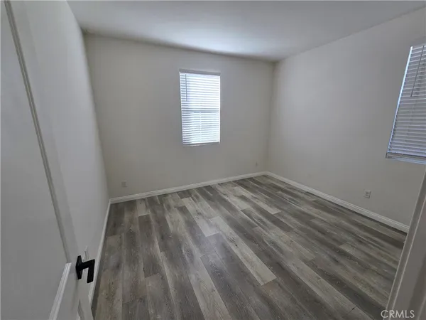 a view of a room with wooden floor and window