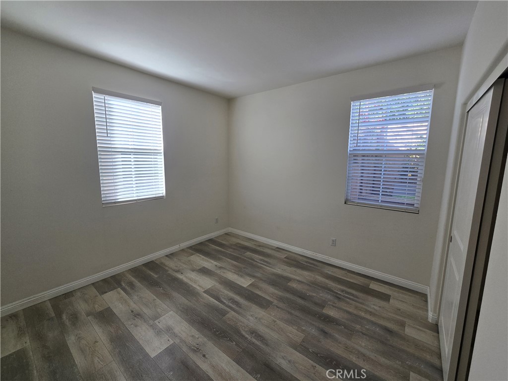 220 West Via Rua Flores Ontario, CA 91762 - Photo 6 of 51 a view of an empty room with wooden floor and a window