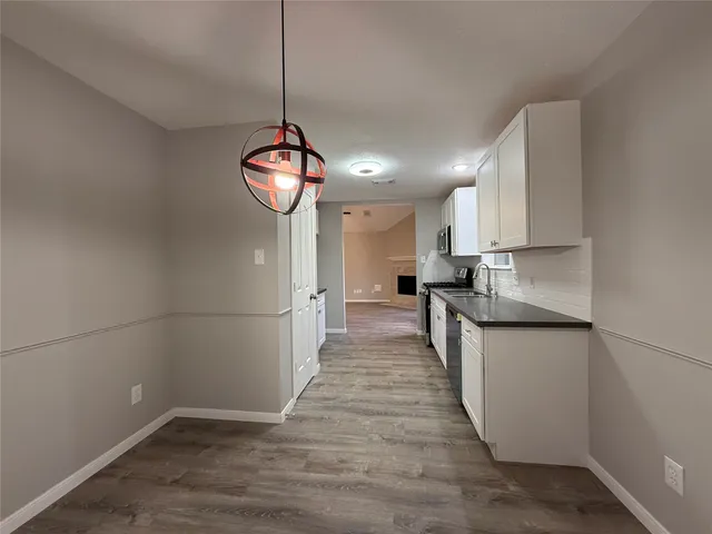 a kitchen with kitchen island a counter top space a sink and cabinets