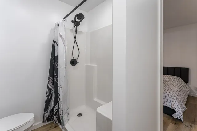 a bedroom with two beds and ceiling fan