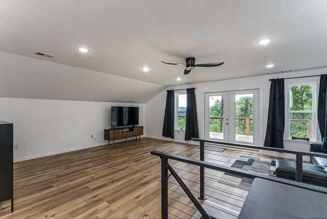 a living room with furniture and a wooden floor