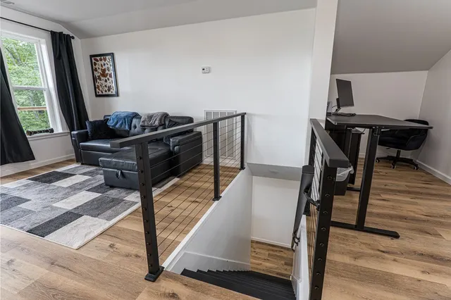 a view of balcony with wooden floor and fence