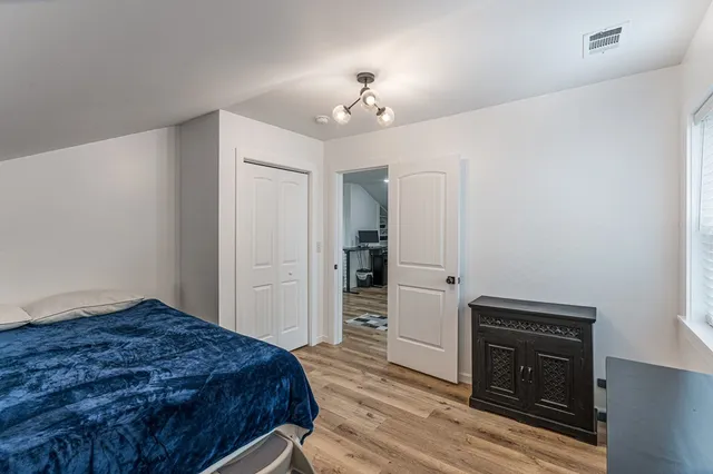 a bathroom with a double vanity sink a mirror and a window
