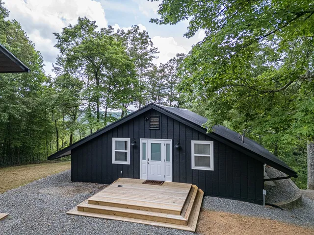 a kitchen with stainless steel appliances a refrigerator a stove a sink a dining table and chairs