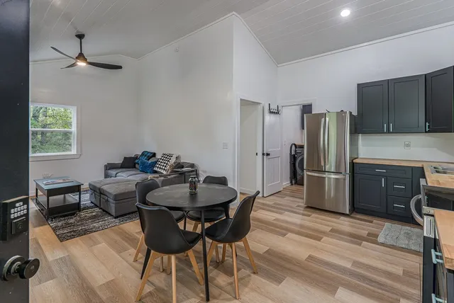 a view of a house with backyard and trees