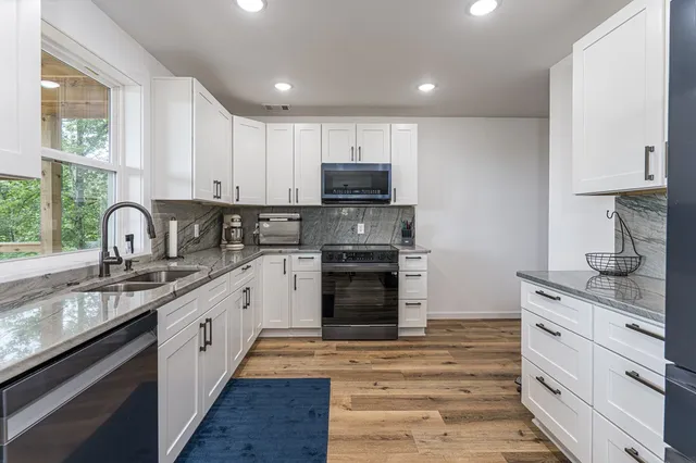 a kitchen with a sink cabinets and window