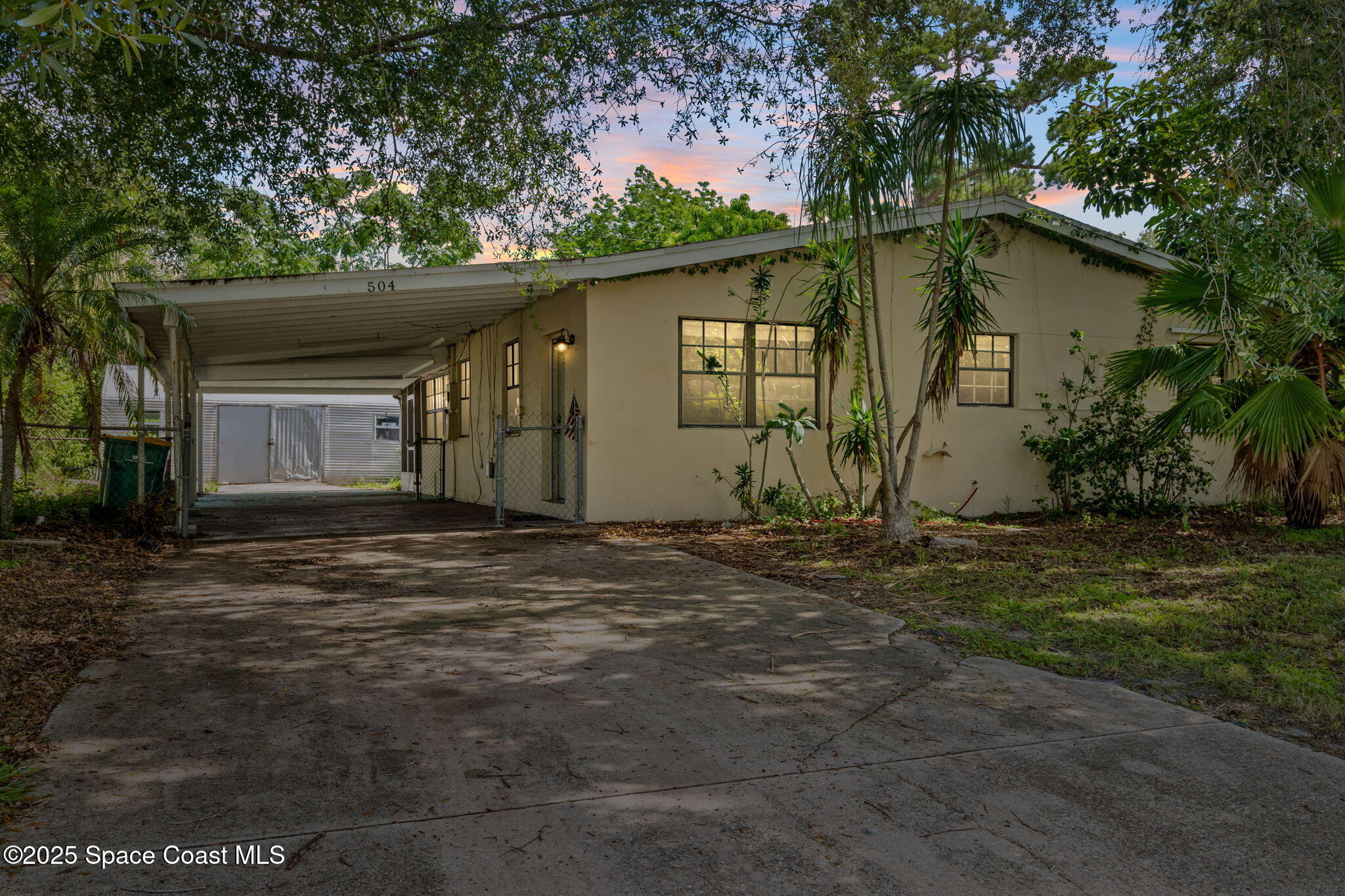 504 Cornell Avenue Melbourne, FL 32901 - Photo 1 of 24 a backyard of a house with plants and trees