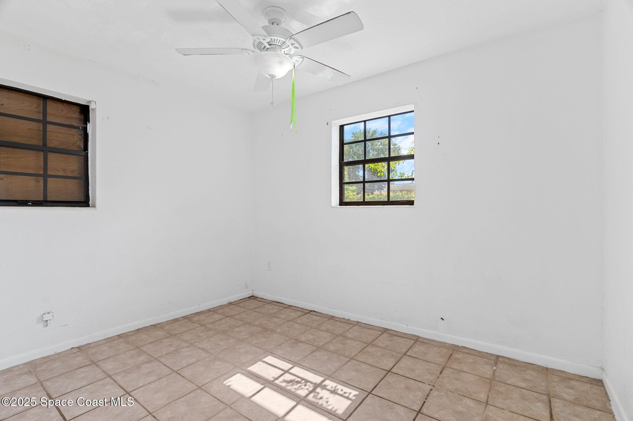 504 Cornell Avenue Melbourne, FL 32901 - Photo 11 of 24 an empty room with windows and fan