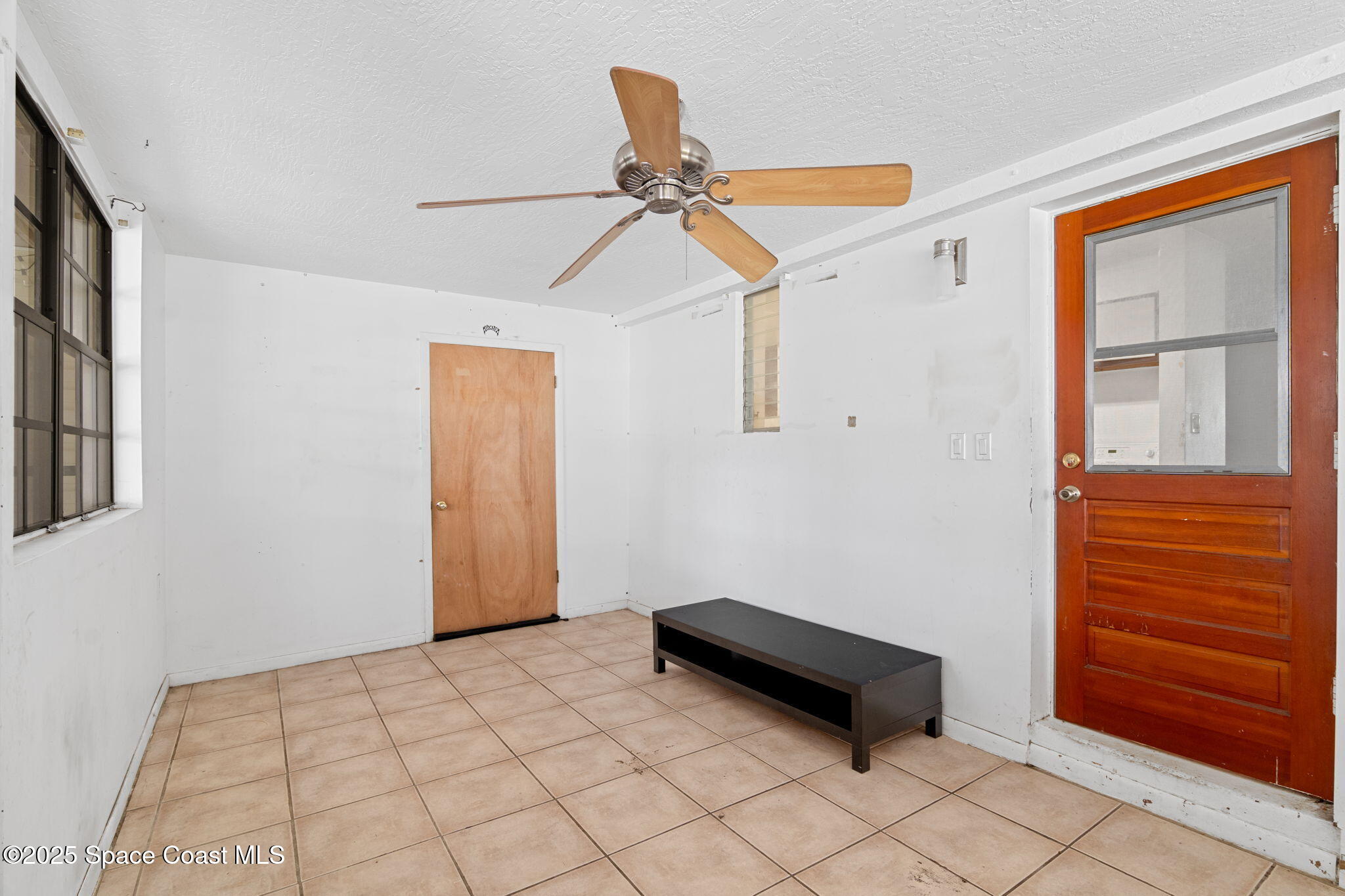 504 Cornell Avenue Melbourne, FL 32901 - Photo 15 of 24 a room with a window and a ceiling fan