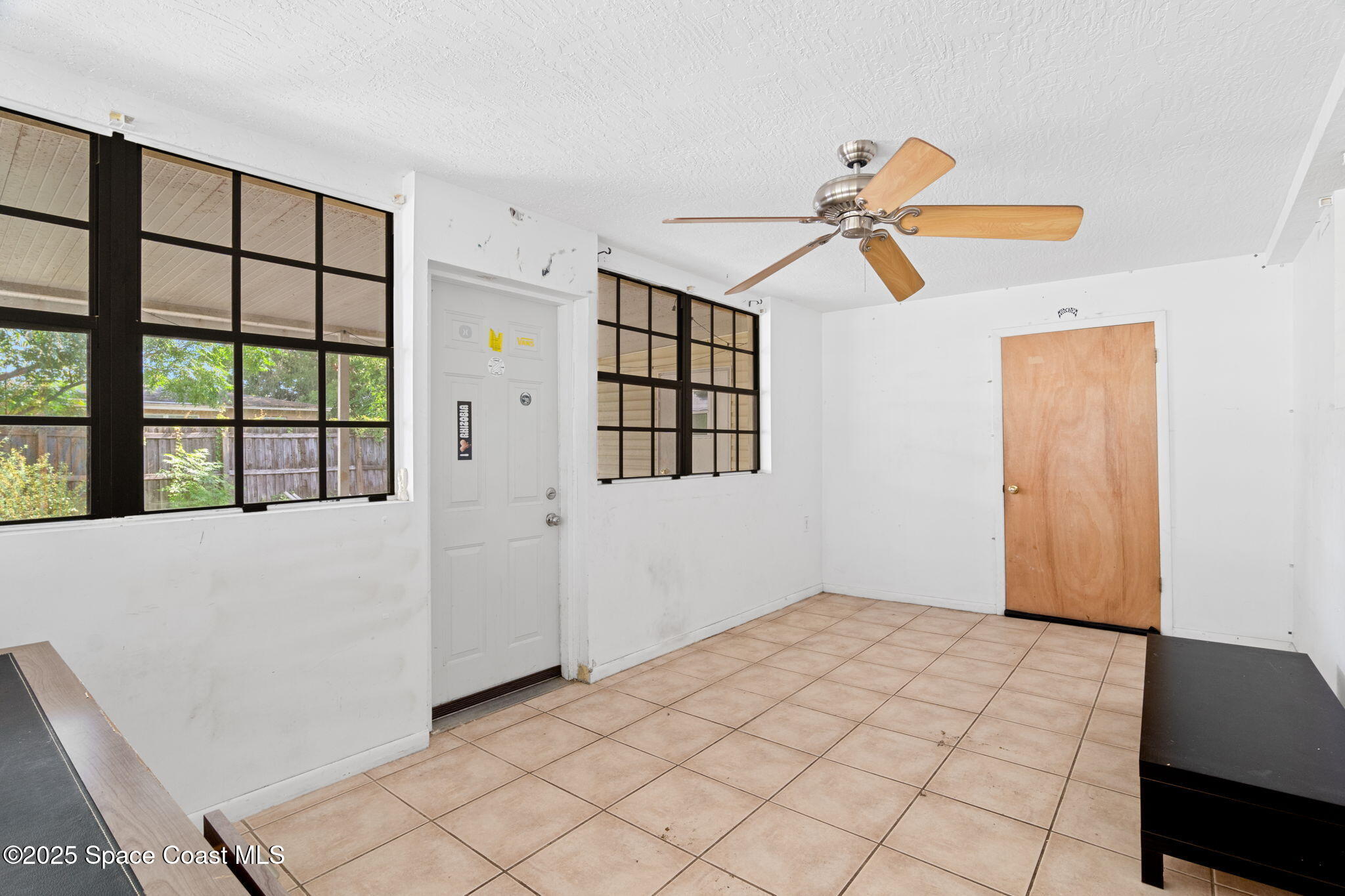504 Cornell Avenue Melbourne, FL 32901 - Photo 16 of 24 a view of a room with a ceiling fan and a window