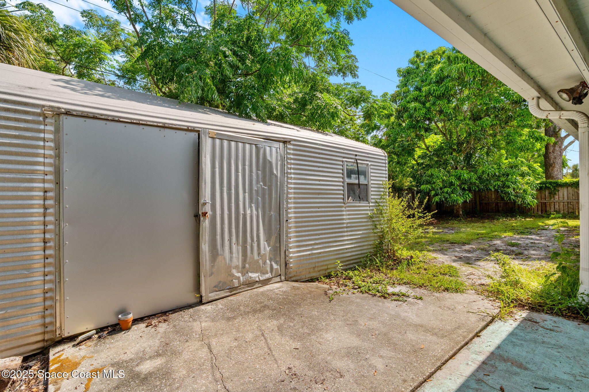 504 Cornell Avenue Melbourne, FL 32901 - Photo 22 of 24 a view of a backyard with plants and large tree