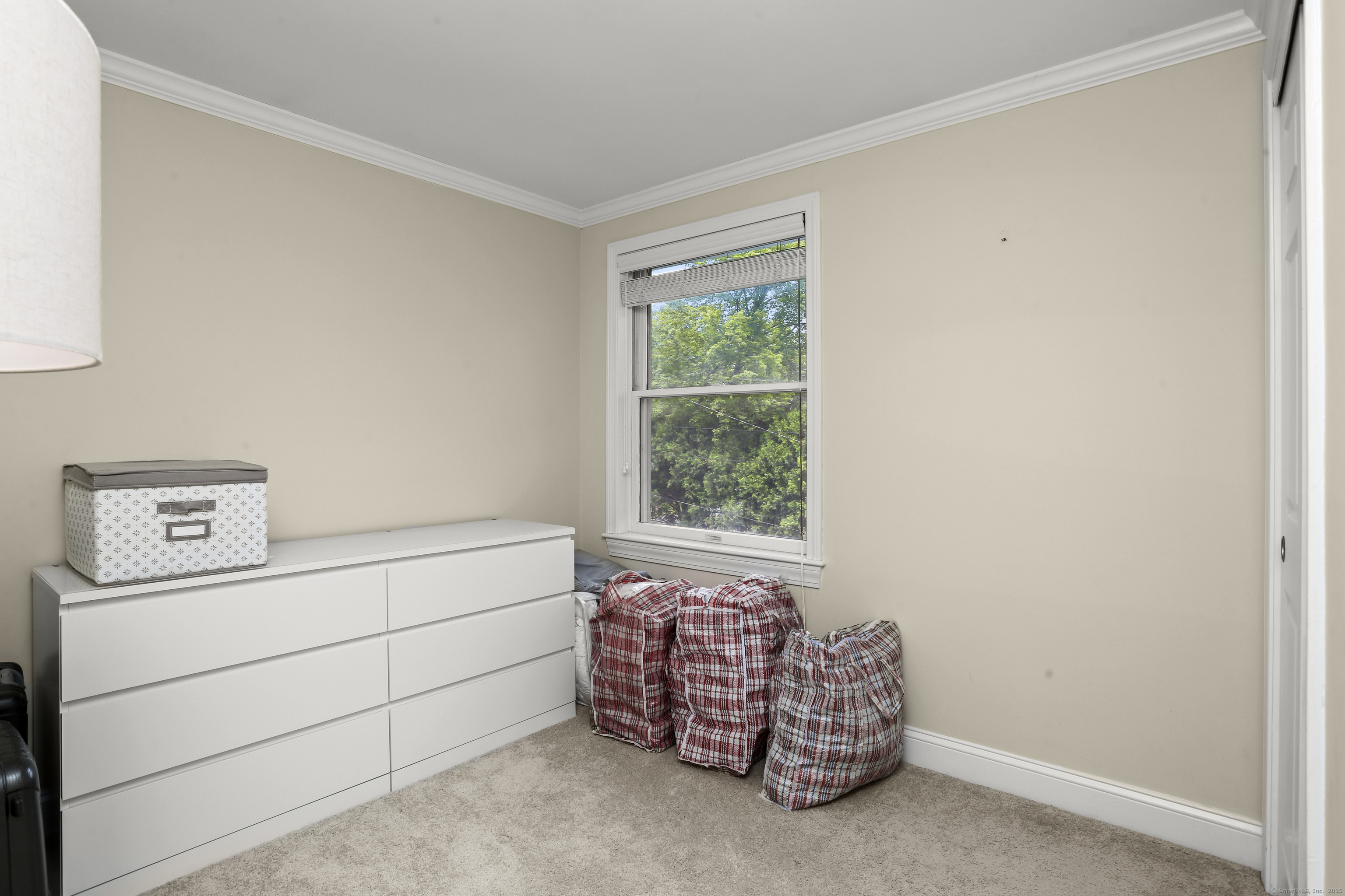 110 Weaver Street, Unit B Greenwich, CT 06831 - Photo 13 of 19 a room with a baby crib and a dresser