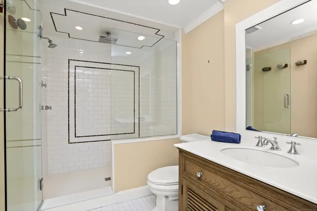 a bathroom with a sink a toilet and shower