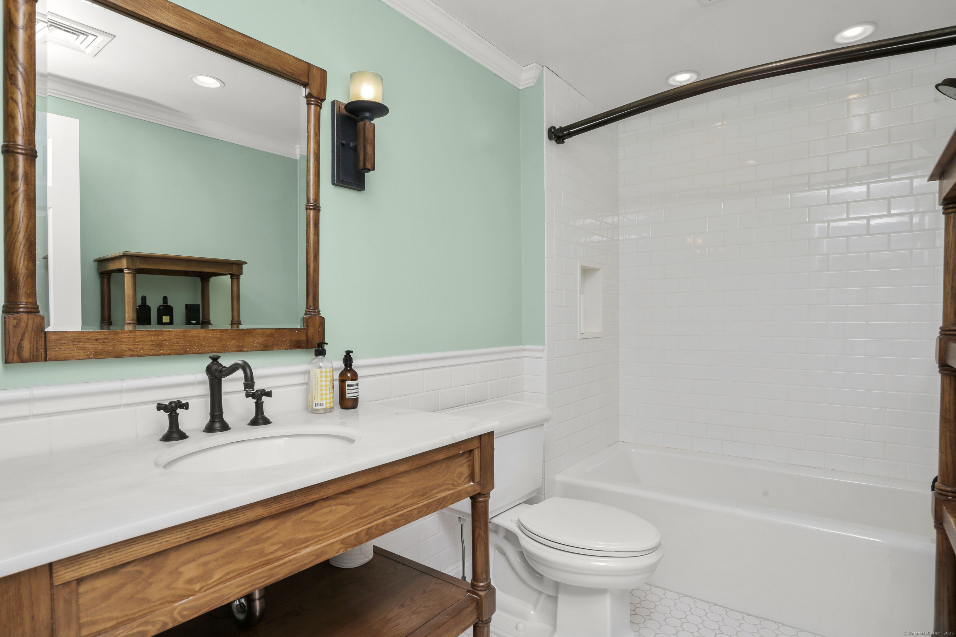 110 Weaver Street, Unit B Greenwich, CT 06831 - Photo 15 of 19 a bathroom with a sink a toilet a mirror and shower