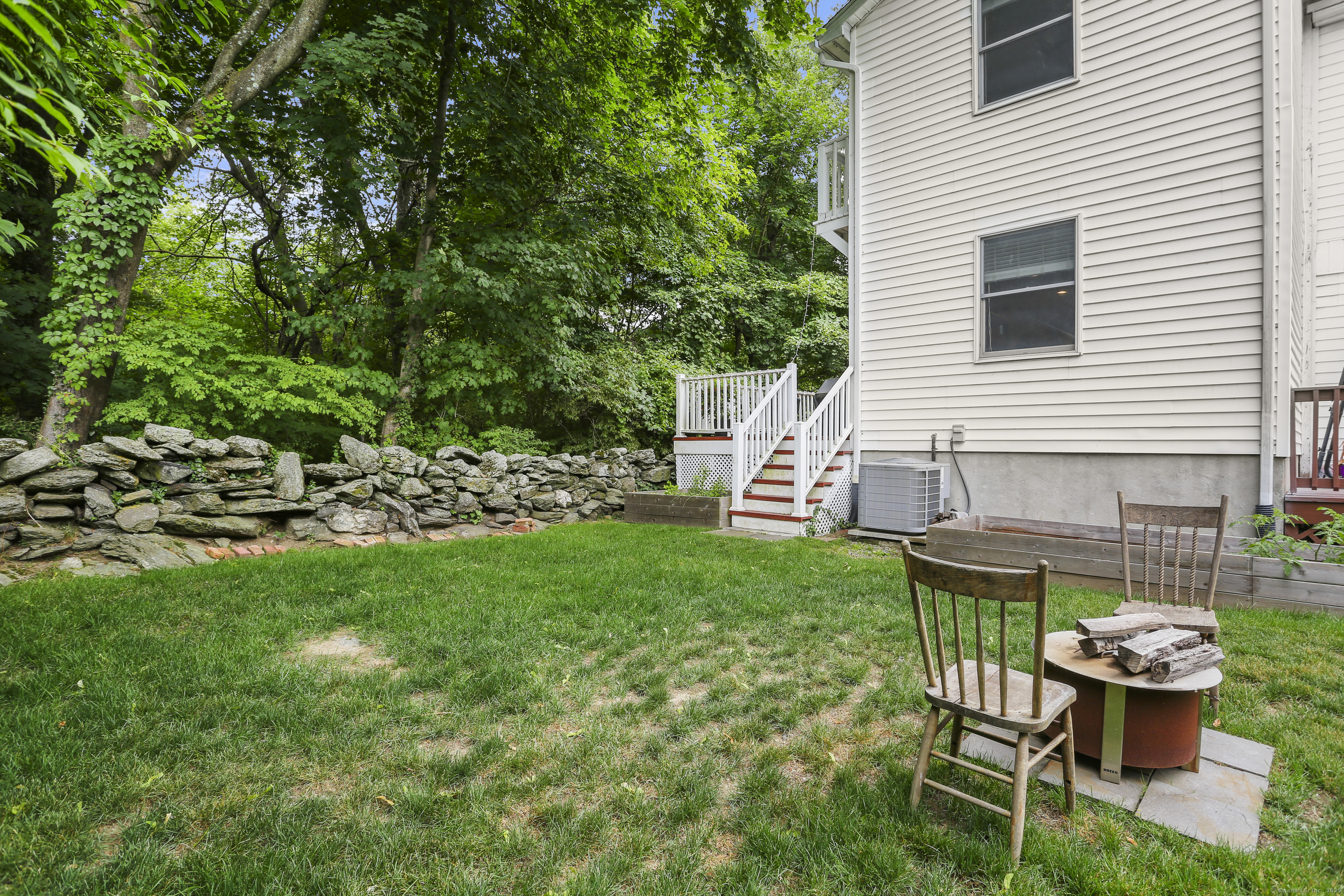 110 Weaver Street, Unit B Greenwich, CT 06831 - Photo 19 of 19 a view of a chair and table in backyard