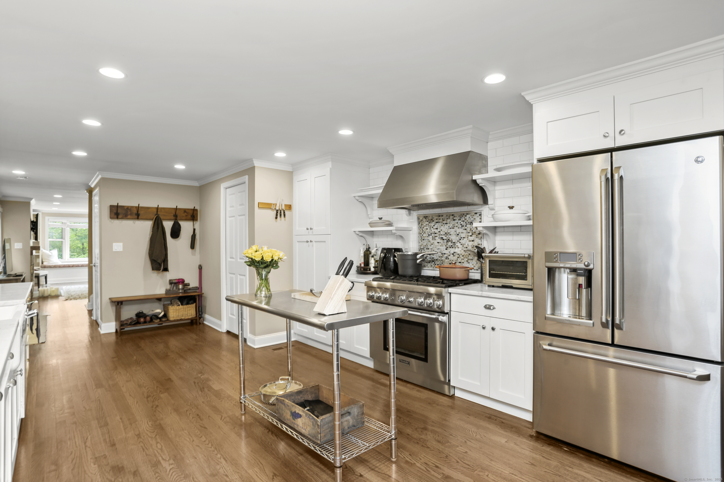 110 Weaver Street, Unit B Greenwich, CT 06831 - Photo 4 of 19 a kitchen with stainless steel appliances granite countertop a refrigerator a stove a sink dishwasher and a refrigerator with wooden floor