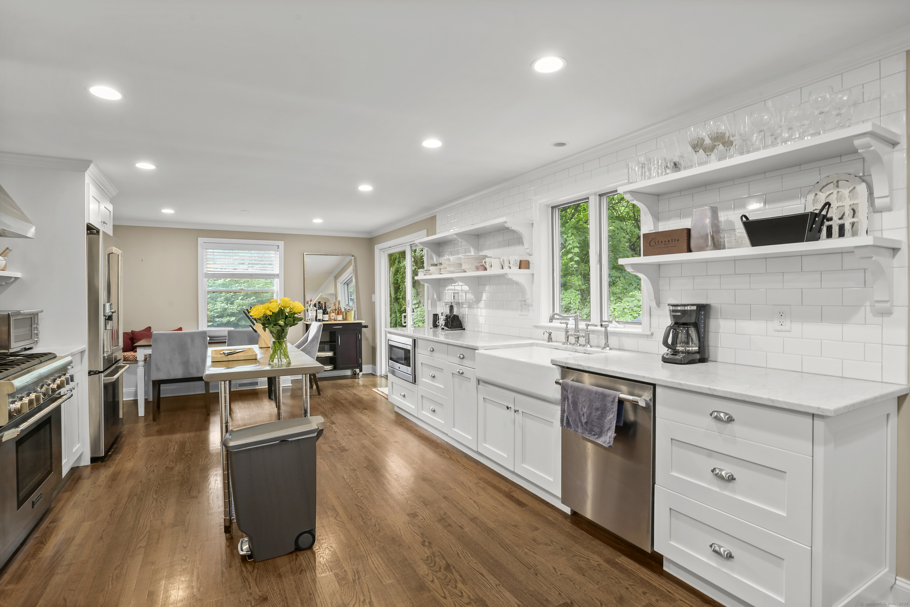 110 Weaver Street, Unit B Greenwich, CT 06831 - Photo 5 of 19 a kitchen with stainless steel appliances granite countertop lots of counter top space and wooden floor