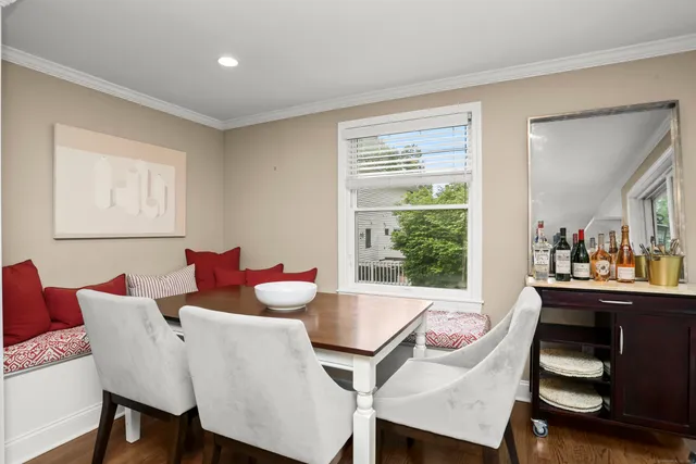 a view of a dining room with furniture and a window