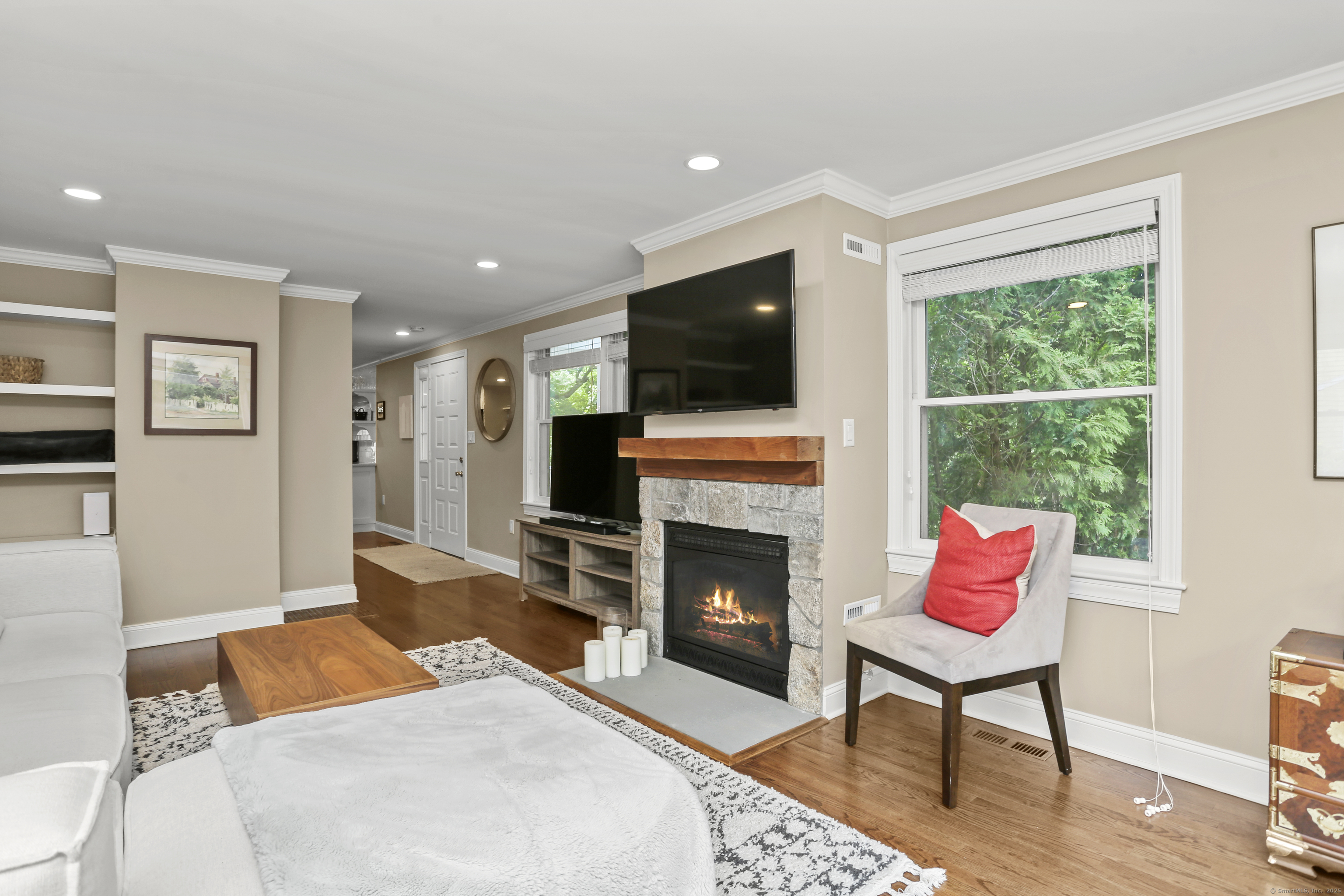 110 Weaver Street, Unit B Greenwich, CT 06831 - Photo 7 of 19 a living room with furniture a flat screen tv and a fireplace