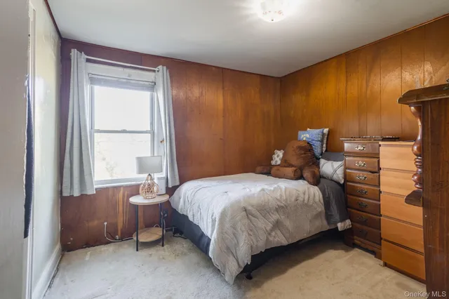 a bed sitting in a bedroom next to a window