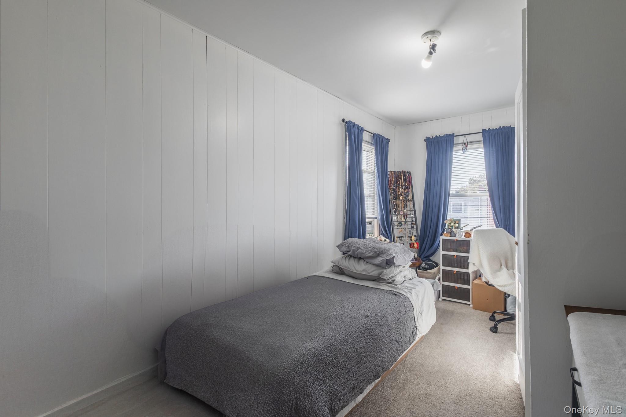 135-01 232nd Street Queens, NY 11413 - Photo 21 of 22 a bedroom with a bed and a window
