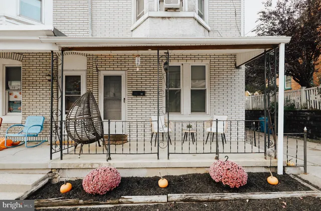a front view of a house with a chair