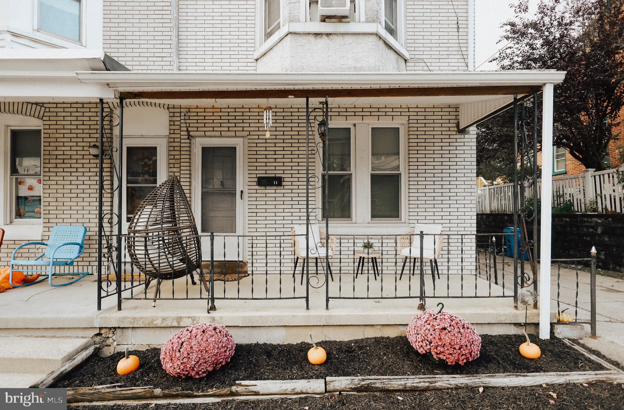 a front view of a house with a chair