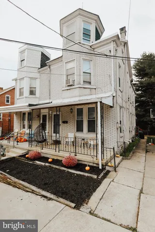 a front view of a residential apartment building with a yard