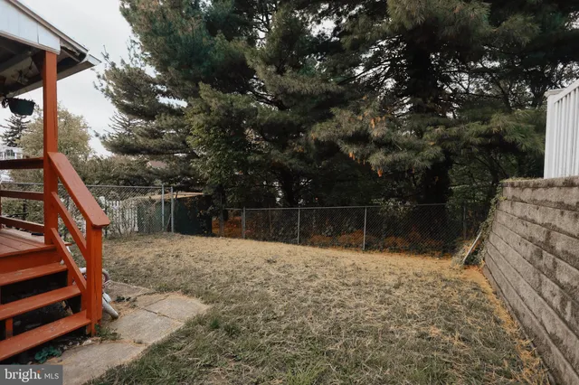 a backyard of a house with lots of trees